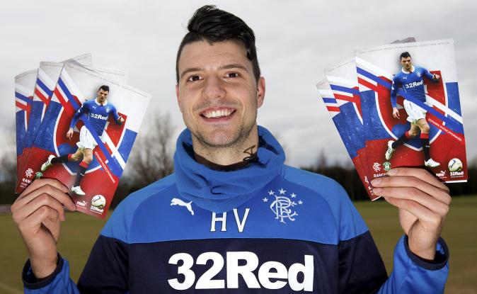 A photo of Rangers' SLOVENIAN loan signing, Haris Vuckic, posing with match programme, emblazoned with Slovakian flag