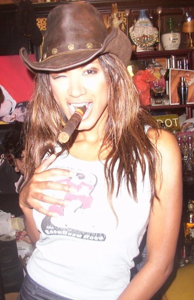 Traci Bingham smoking a cigarette (or weed)
