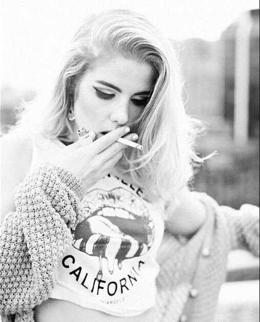 Emily Bett Rickards smoking a cigarette (or weed)
