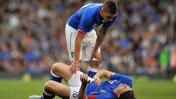 Italy's Montolivo (down) writhes in pain [via @FIFAWorldCup]