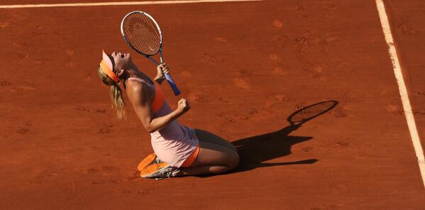 Sharapova kneels in joy after beating Halep [via @RolandGarros]