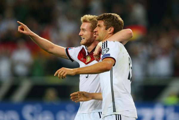 Schürrle celebrates with goalscorer Müller [via @FIFAcom]