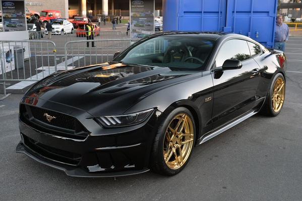 Black mustang sitting on gold wheels - scoopnest.com