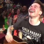 Garth Brooks gives guitar to fan during concert Garth Brooks gives guitar to fan during concert