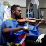 Amid chaos of Venezuela street demos, a lone violinist plays Amid chaos of Venezuela street demos, a lone violinist plays