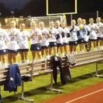High school soccer teams sing national anthem before game