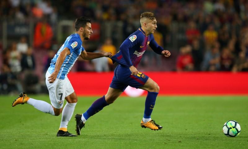 Controversial Deulofeu goal helps Barca ease past Malaga