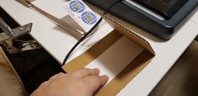 手作業で1冊ずつ帯がけ。この段ボールの帯折り器はビッグバンセオリーのシェルドンの使ってた洗濯物畳み器にヒントを得たヲタ友 手作業で1冊ずつ帯がけ。この段ボールの帯折り器はビッグバンセオリーのシェルドンの使ってた洗濯物畳み器にヒントを得たヲタ友
