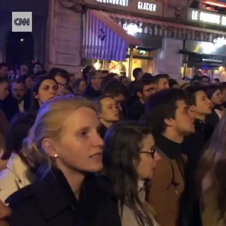 Crowds gathered to sing hymns outside the Notre Dame cathedral on Monday evening after the Parisian landmark was engulfed in flames https://cnn.it/2UK4AYE