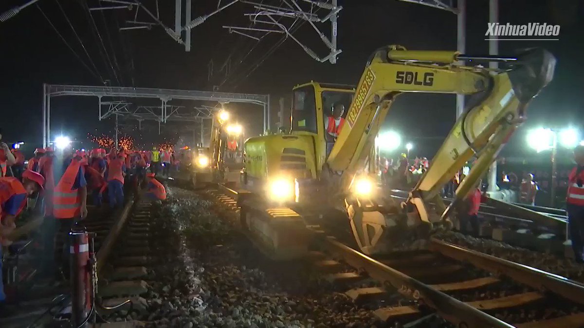 Amazing speed: 1,000+ staff work 8 hours overnight to link an under-construction railway to China's sprawling high-speed rail network.