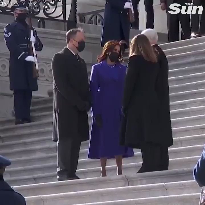Kamala Harris waves goodbye to Mike Pence as he leaves the White House