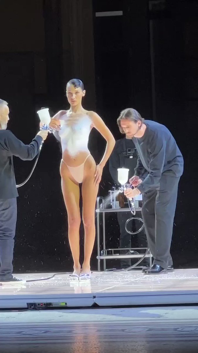 For spring 2023, #Coperni dedicated its runway to “women of this world.” The main event? @bellahadid taking front and center stage while three men spray-painted a dress onto her body. 