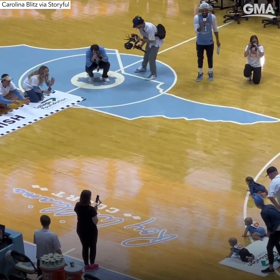 Five babies competed in a crawling contest at a college basketball game