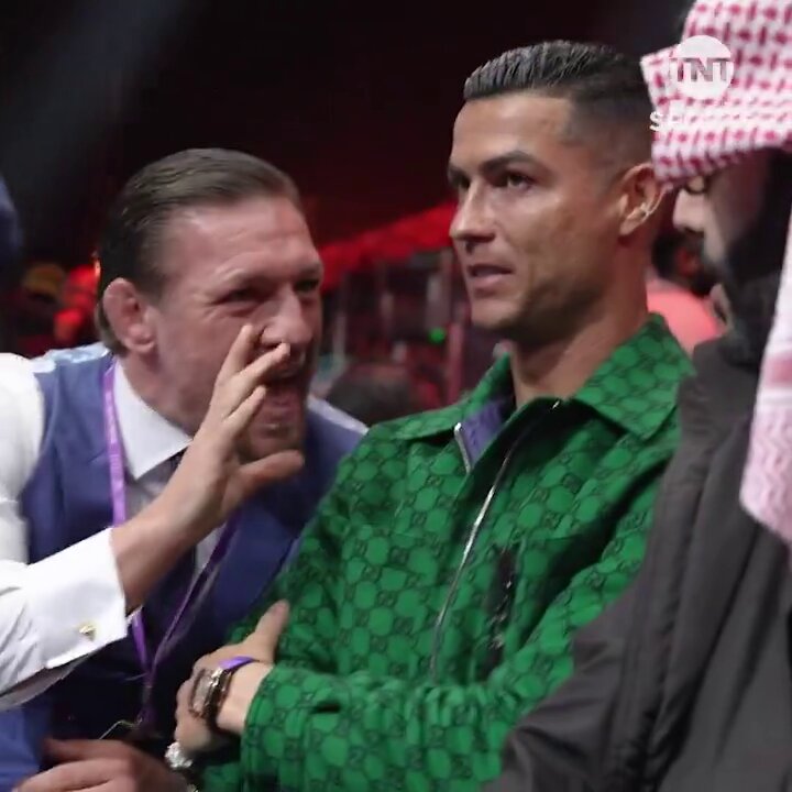 Conor McGregor speaking to someone with Cristiano Ronaldo next to him