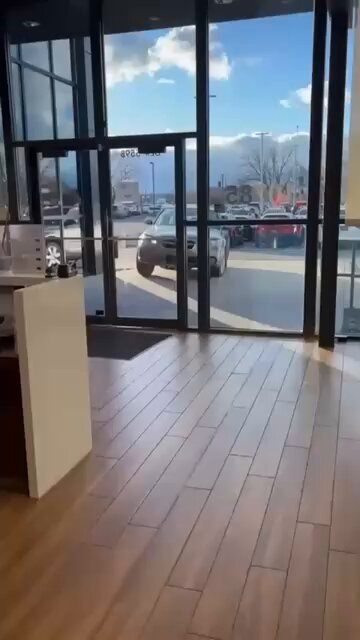Man crashes car into dealership showroom due to overcharge. 