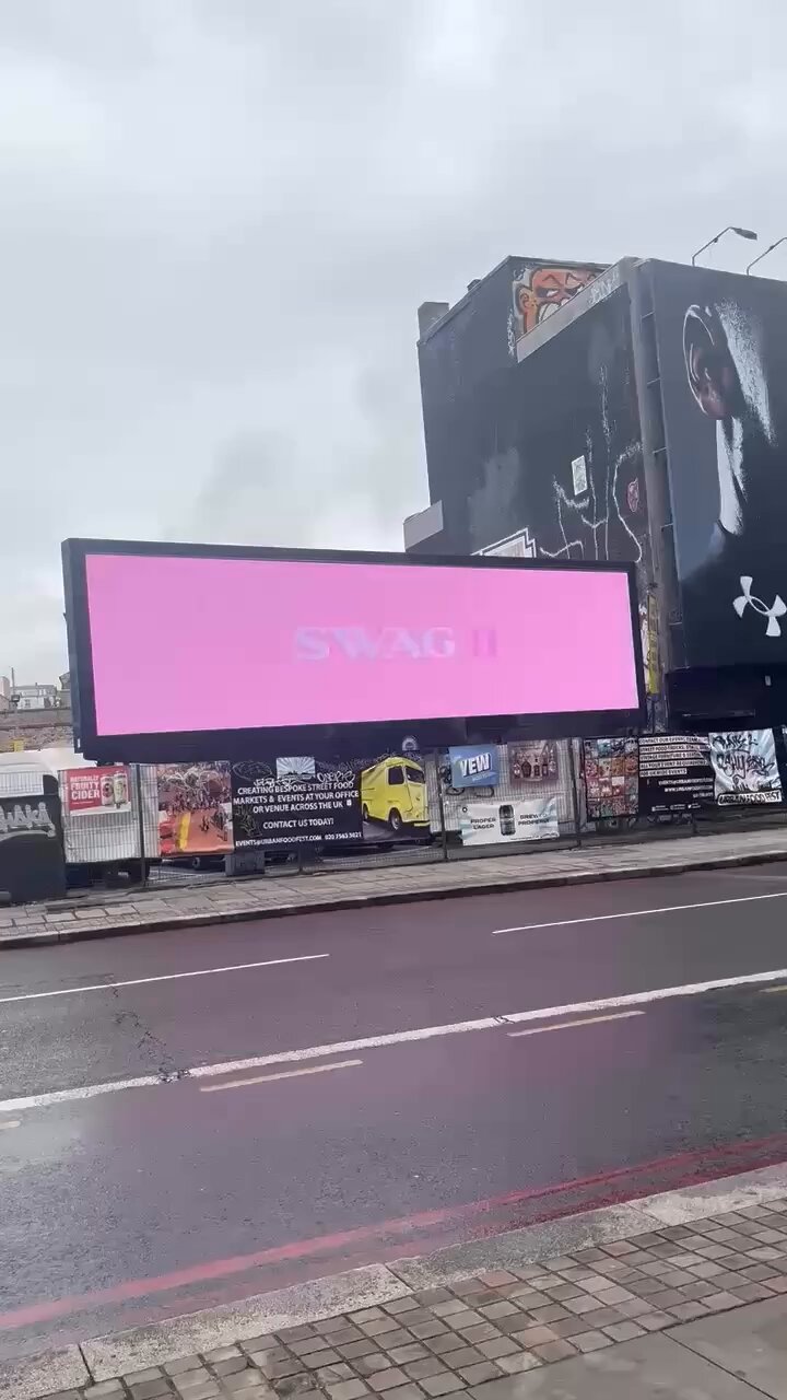 A vivid pink 'SWAG' billboard