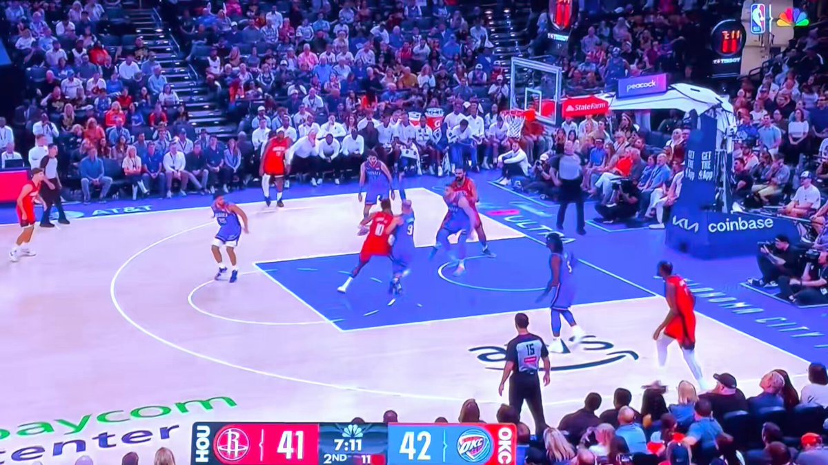 Remember: in order to be considered a dribble, the ball must be in the player's control. A batted ball to the floor is simply NOT control according to NBA standards, so Okogie can then begin a dribble, despite the OKC bench protestations. 