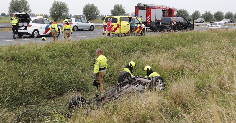 Auto op de kop in sloot bij ongeval op A50 Herpen