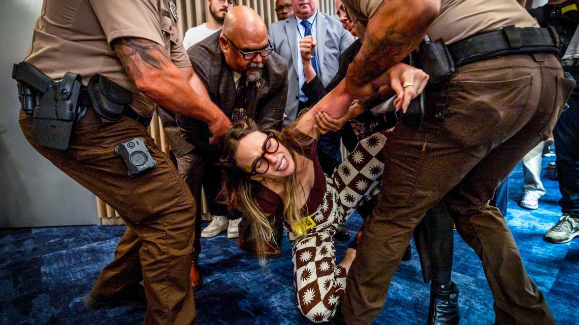MarbinMiller's tweet card. County sheriff’s deputies dragged out a 36-year-old woman who ignored an officer who told her not to speak.