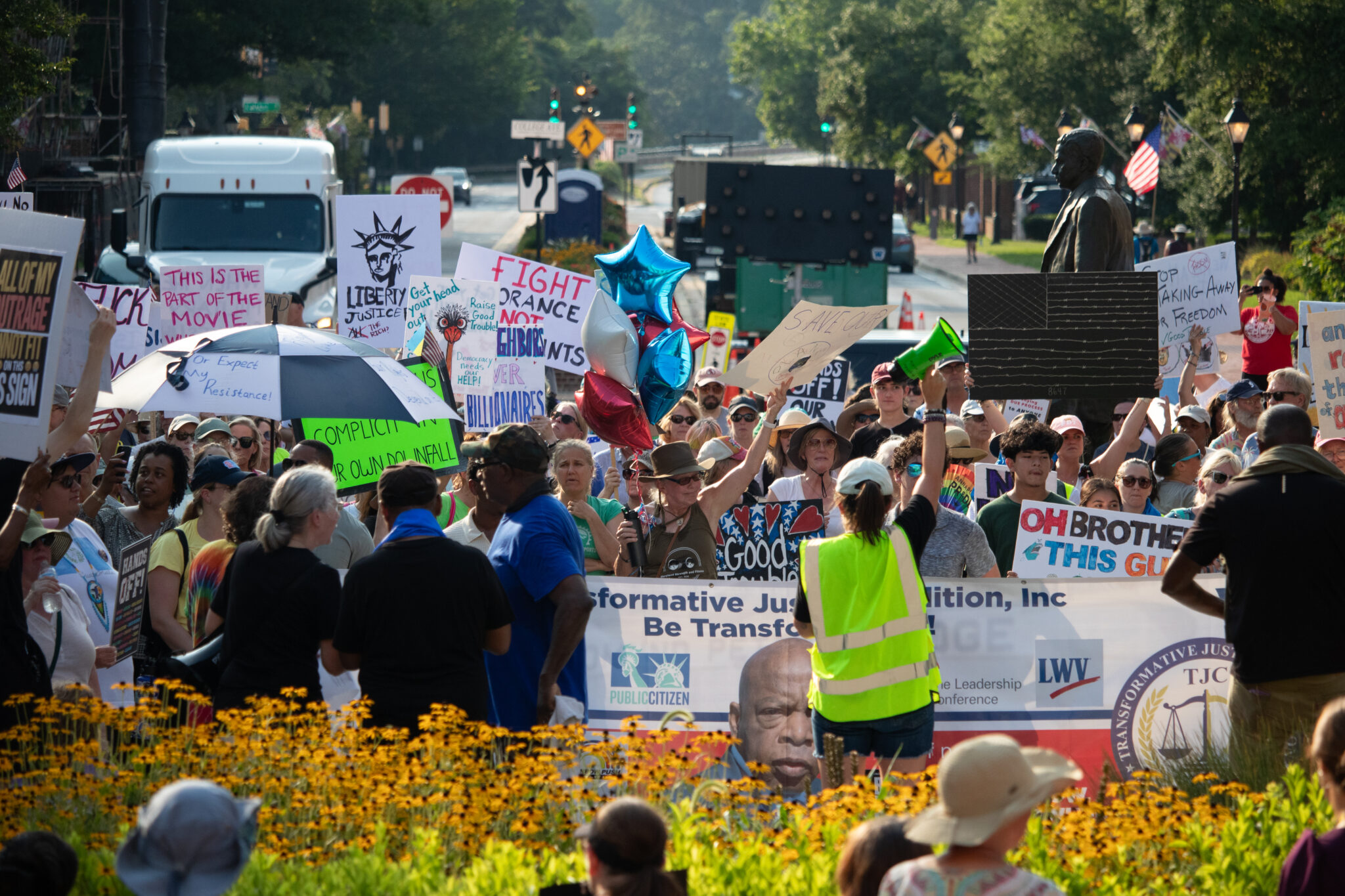 SamGauntt's tweet card. Hundreds of peaceful, sign-carrying protesters gathered on Lawyers Mall in the oppressive heat of a late July afternoon Thursday to protest Trump administration policies and to make the "good...