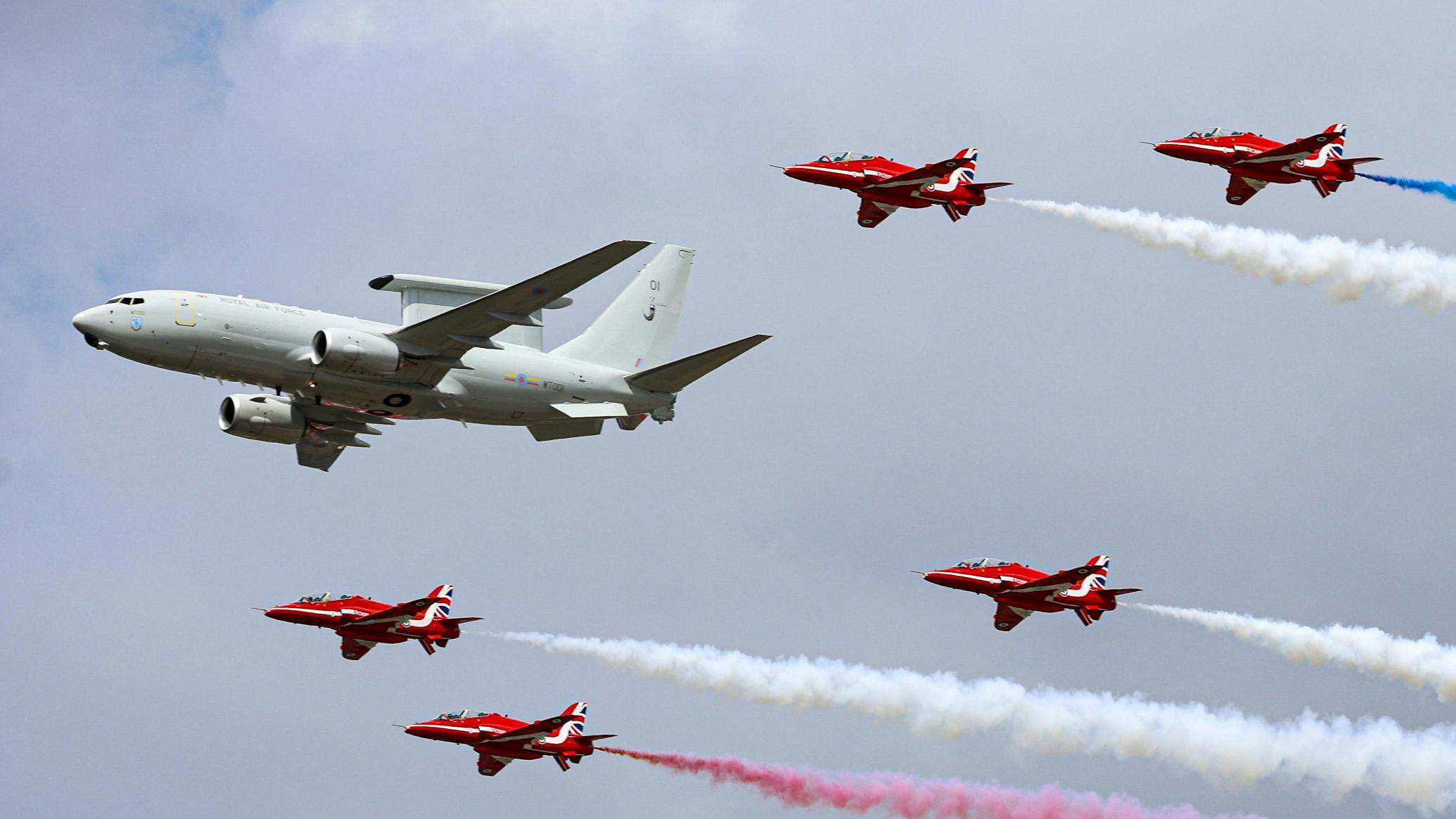 UKDefJournal's tweet card. The first British E-7 Wedgetail Airborne Early Warning and Control aircraft has made its first ever flypast with the Red Arrows at the Royal International Air Tattoo (RIAT) 2025 in Gloucestershire.