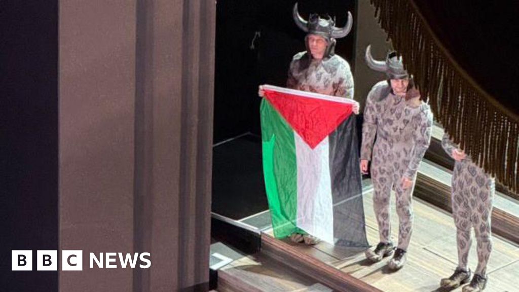 ianssmart's tweet card. A cast member unfurls a Palestinian flag during a curtain call, prompting a brief scuffle as an official tries to take it away.