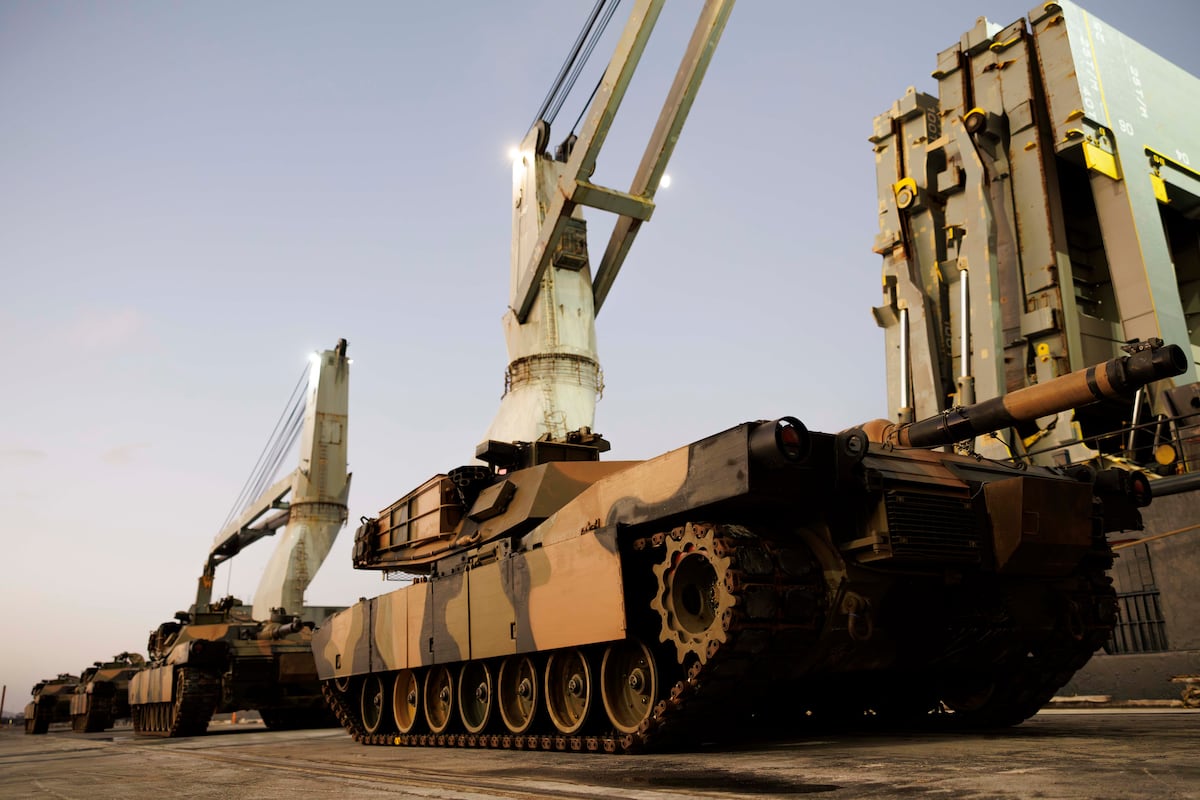 MissionArtist's tweet card. The U.S.-built tanks, still painted in their AusCam camouflage scheme, had been loaded onto a commercial cargo ship in Geelong, Australia, in May 2025.