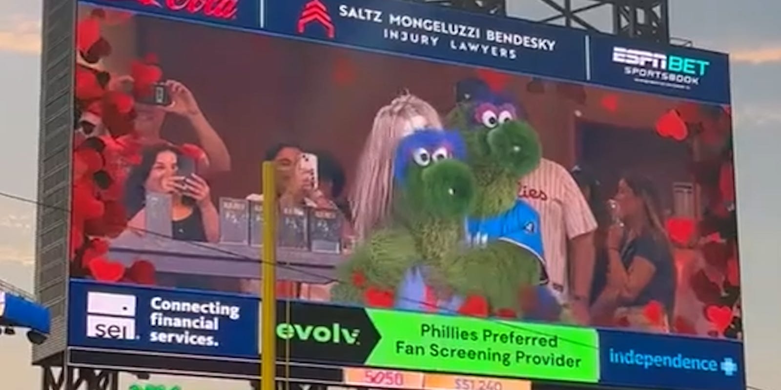 AUG_Chronicle's tweet card. During a recent Philadelphia Phillies game, mascot Phillie Phanatic reenacted the viral Coldplay concert kiss cam, sparking cheers from the crowd.