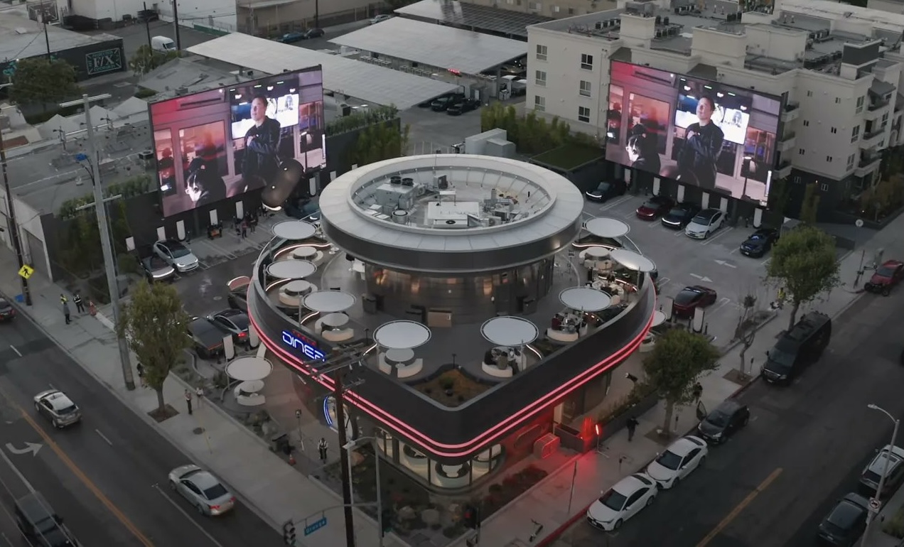 theloftusparty's tweet card. Credit where credit is due. Elon Musk and his team just opened a Tesla Diner (and super-charging center) in LA. It's a great idea. A retro-futuristic diner with drive in movie stuff and some diner...