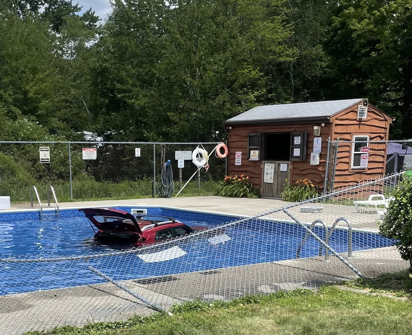 BostonGlobe's tweet card. A car “narrowly” missed swimmers Sunday when the driver accidentally pressed the gas pedal while attempting to park, driving through a four-foot-high chain link fence and into a pool, authorities...