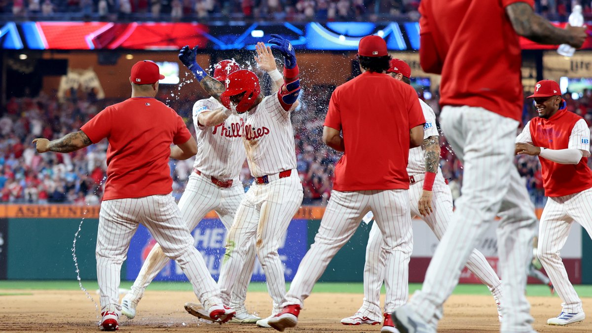 NBCSPhilly's tweet card. Phillies win a wild series opener with the Red Sox in extras, walking it off on catcher’s interference despite going hitless in the final frame.