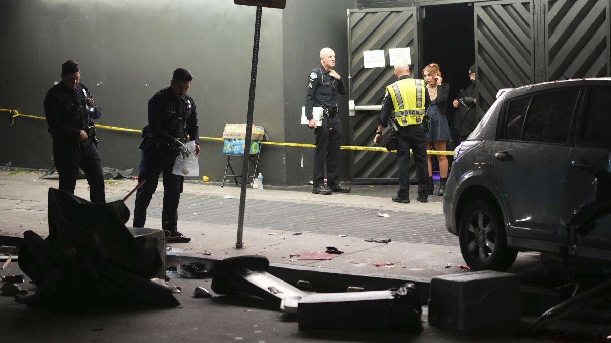 latimes's tweet card. While the gunman is still outstanding, the suspected driver — identified as Fernando Ramirez — is in custody. Video showed Ramirez beaten bloody as police took him away.
