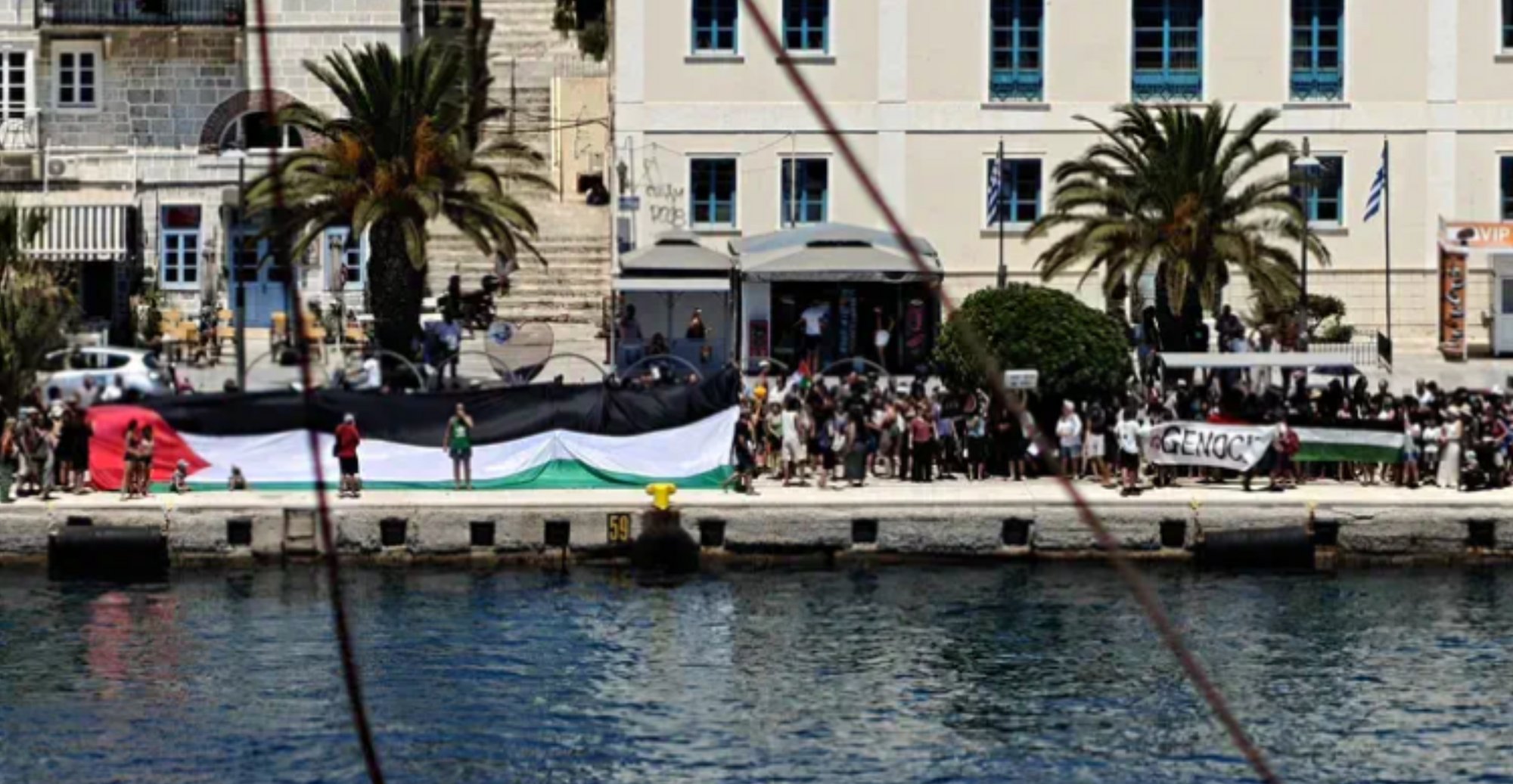 i24NEWS_EN's tweet card. The ferry left Tel Aviv on Sunday and stopped in Rhodes before reaching Syros. Protests at the port forced authorities to keep the Israelies onboard