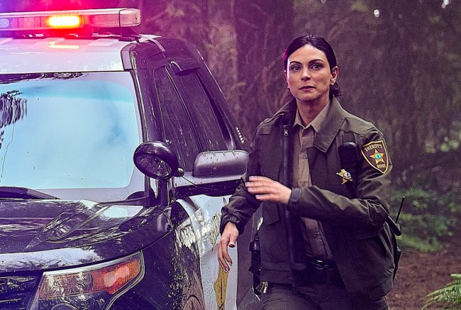 TVLine's tweet card. Why is 'Sheriff Country' filming across the country from 'Fire Country'? Spinoff star Morena Baccarin shares the very personal reason.