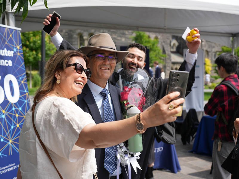 UofTCompSci's tweet card. Graduates, families and faculty gathered under the tent to celebrate a milestone in computer science at U of T. 
