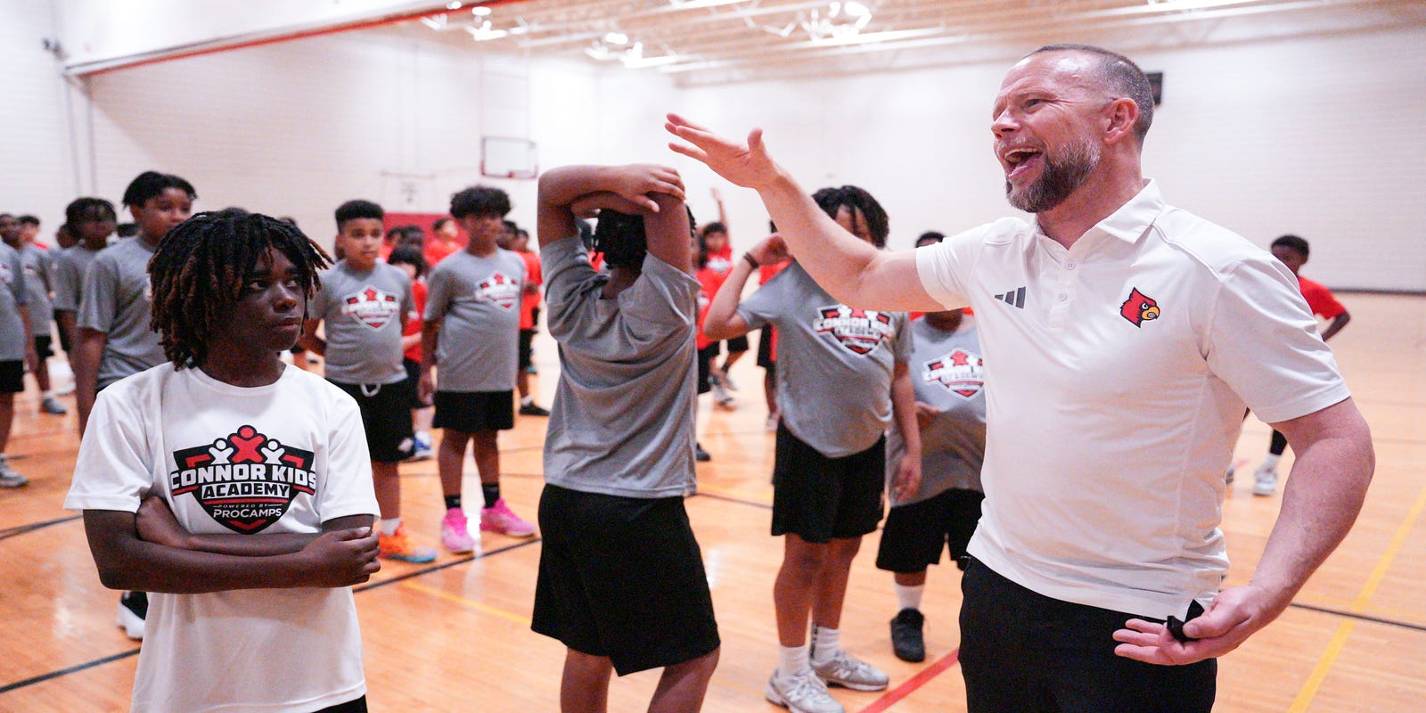 CardsHQ_CJ's tweet card. Louisville basketball coach Pat Kelsey along with some players partnered with Connor Kids Academy to host a summer basketball camp at U of L.