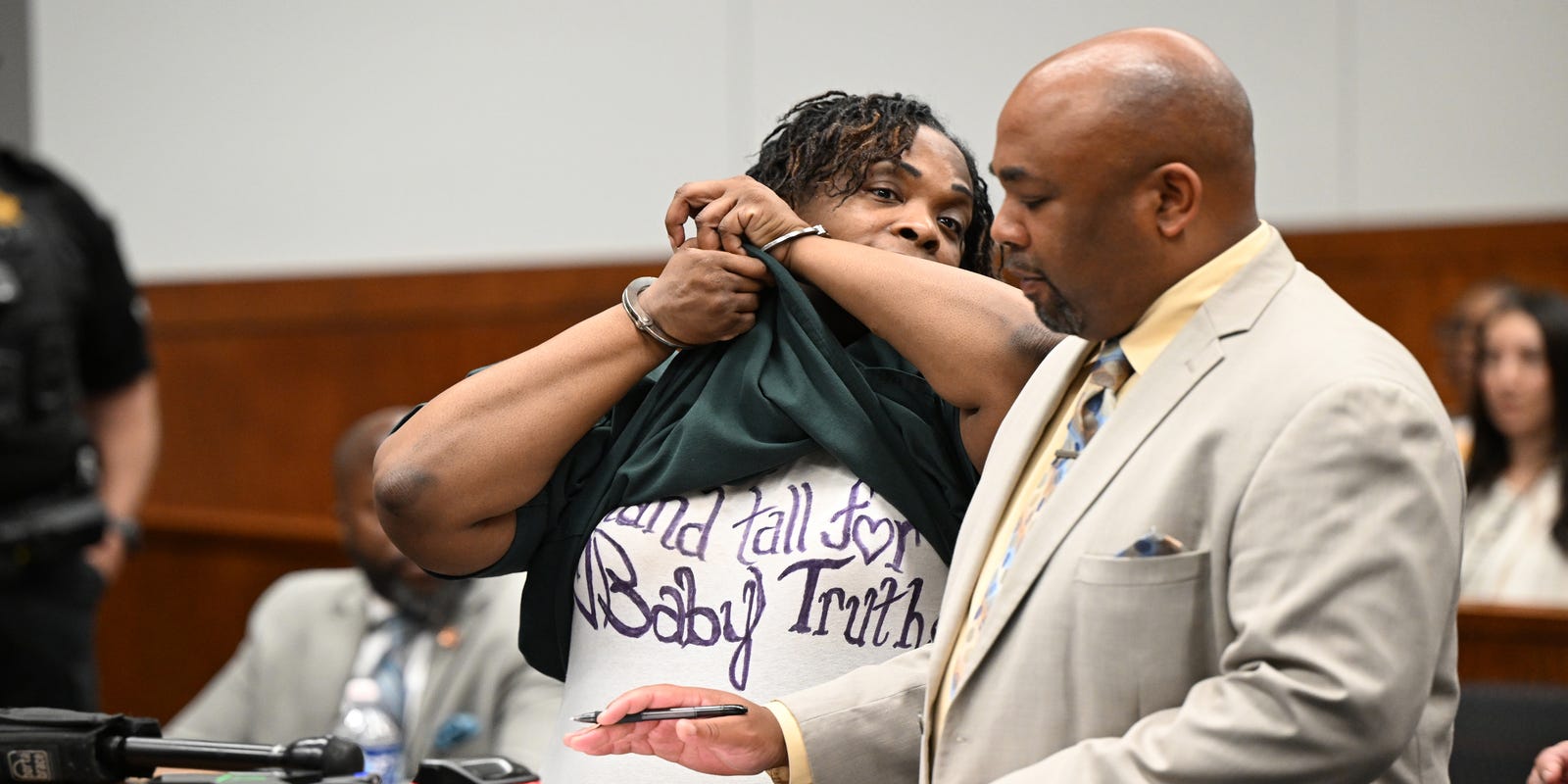 detroitnews's tweet card. At a hearing Tuesday, Shuvonne Vinson also lifted her jail shirt to reveal another shirt with a message with her daughter's name.