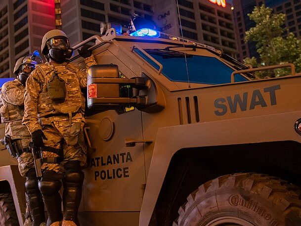 ArmsTradeCT's tweet card. Summary: President Trump rescinded restrictions on the transfer of certain military-style equipment to police on his first day in office. With recent (ICE) raids, this renewed ability of police to...
