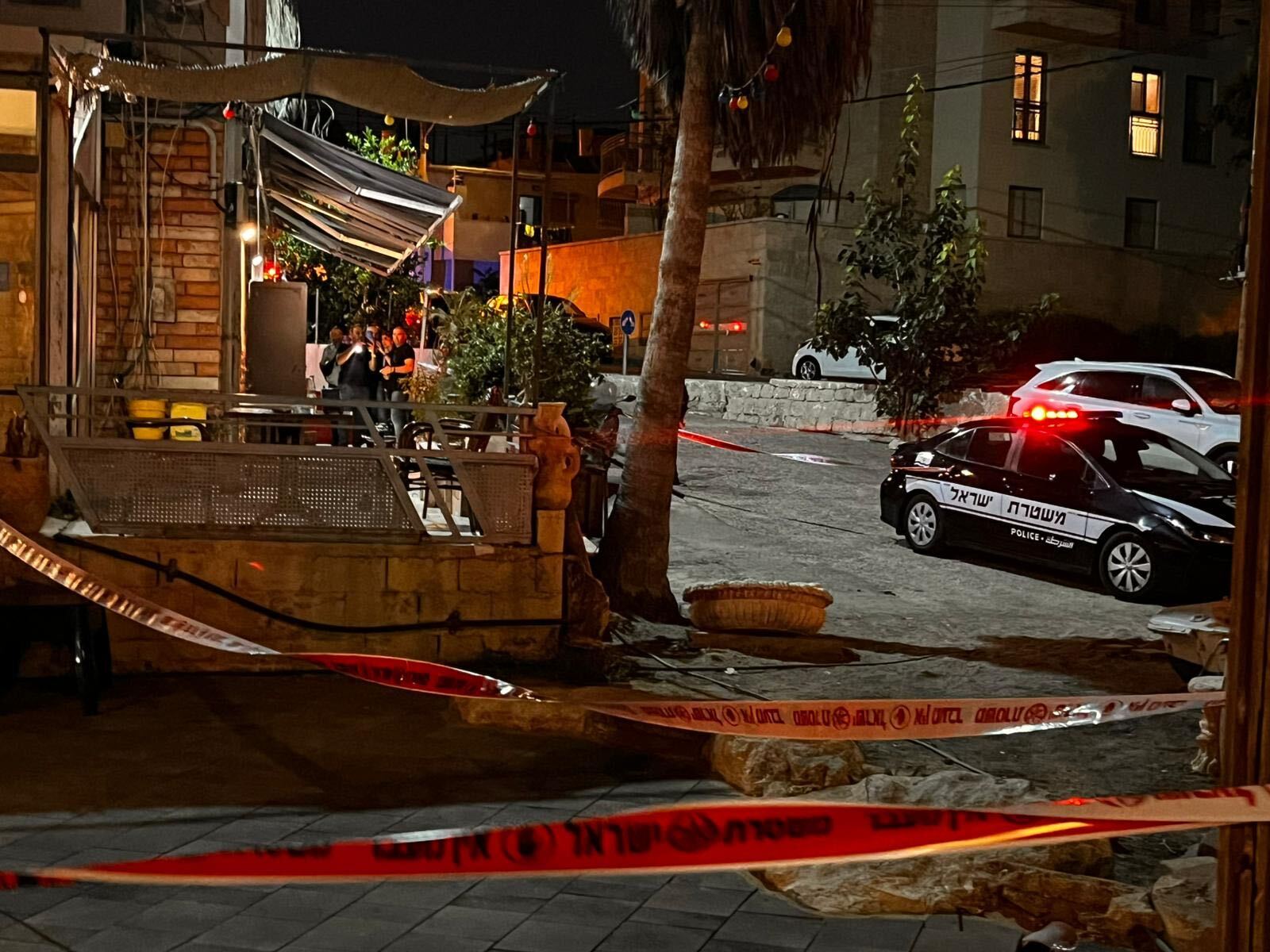 TimesofIsrael's tweet card. Man shot dead at Jaffa cafe; woman found dead in southern streambed, four family members arrested; man gunned down in Lod