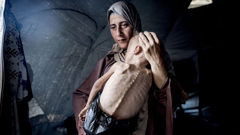 GLAN_LAW's tweet card. Israel denies it is responsible for shortages of food - but aid groups have accused its government of creating "chaos, starvation, and death".