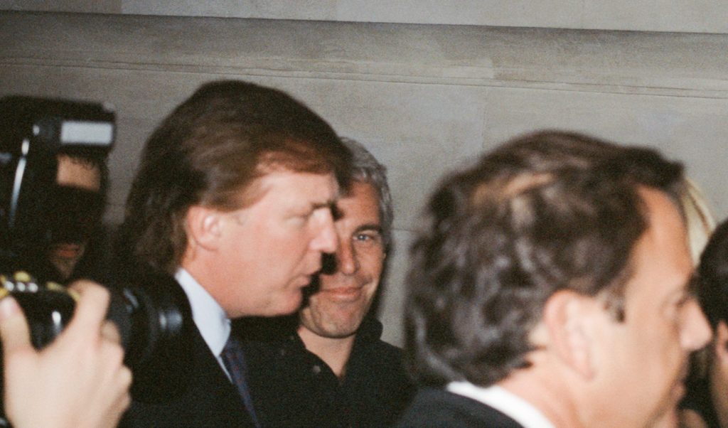 TrumpFile's tweet card. Donald Trump and Jeffrey Epstein attend a Victoria’s Secret Angels event sponsored by Rogers & Cowan at the club Duvet in New York City. The photo is unearthed by the media in July 2025. Photograph:...