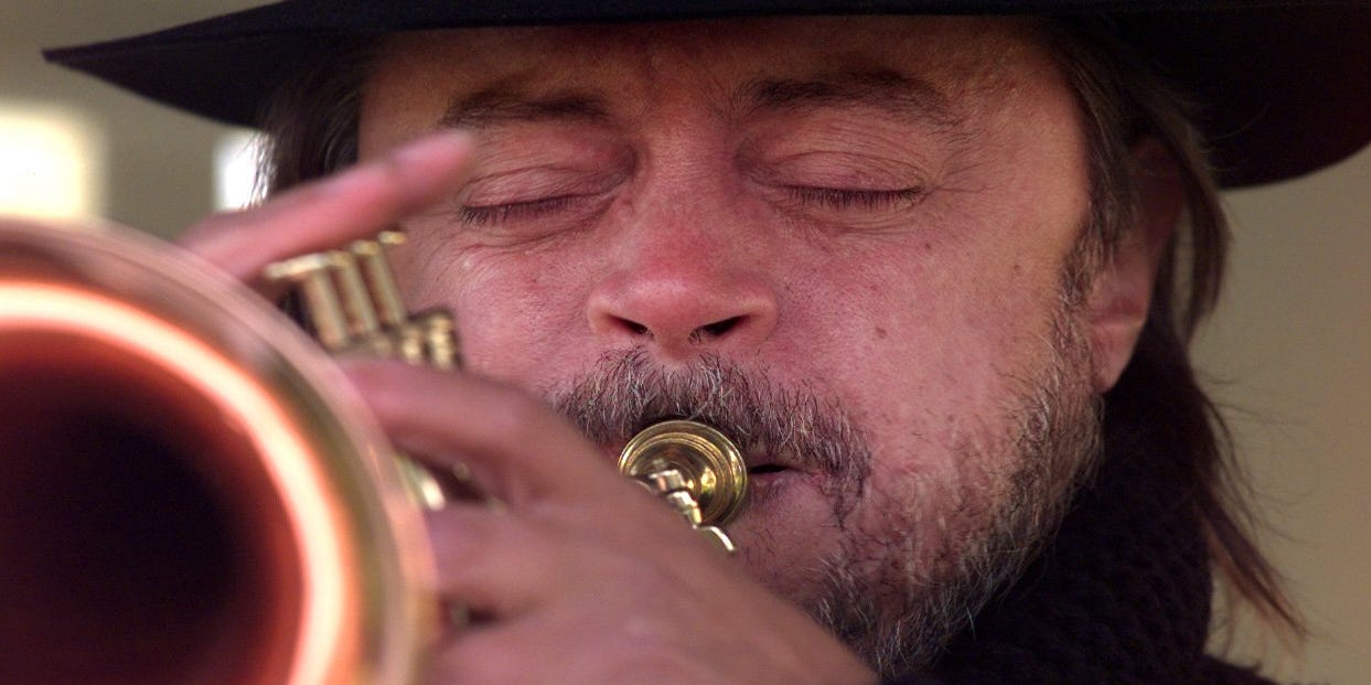 anhonestcon's tweet card. “The family of Chuck Mangione is deeply saddened to share that Chuck peacefully passed away in his sleep at his home in Rochester, New York on July 22, 2025."