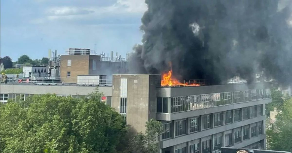 katelallyx's tweet card. Black smoke can be seen billowing from St Michael's hospital