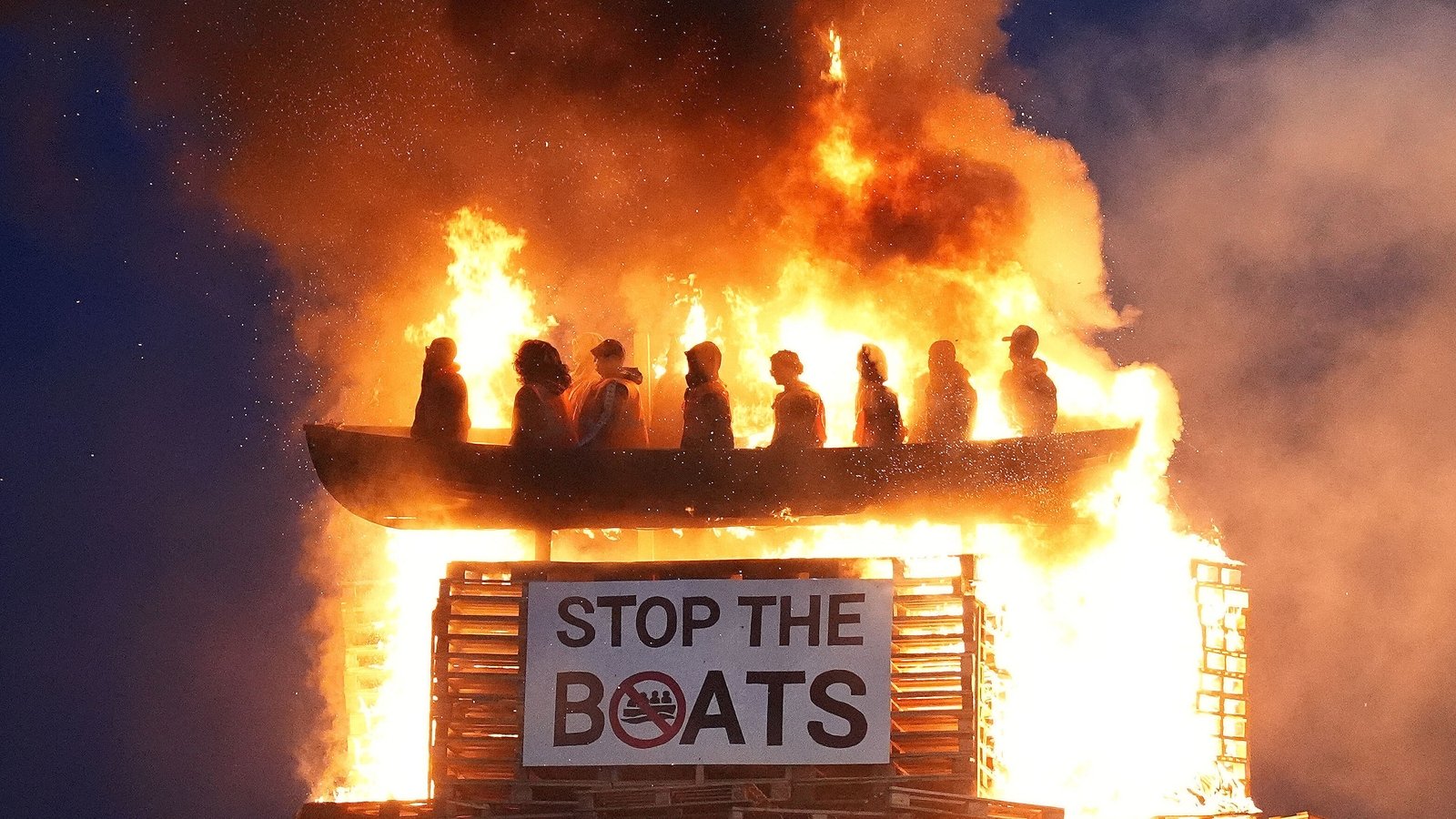 jasonomahony's tweet card. A loyalist bonfire in Co Tyrone controversially topped with an effigy of migrants in a boat was lit last night.