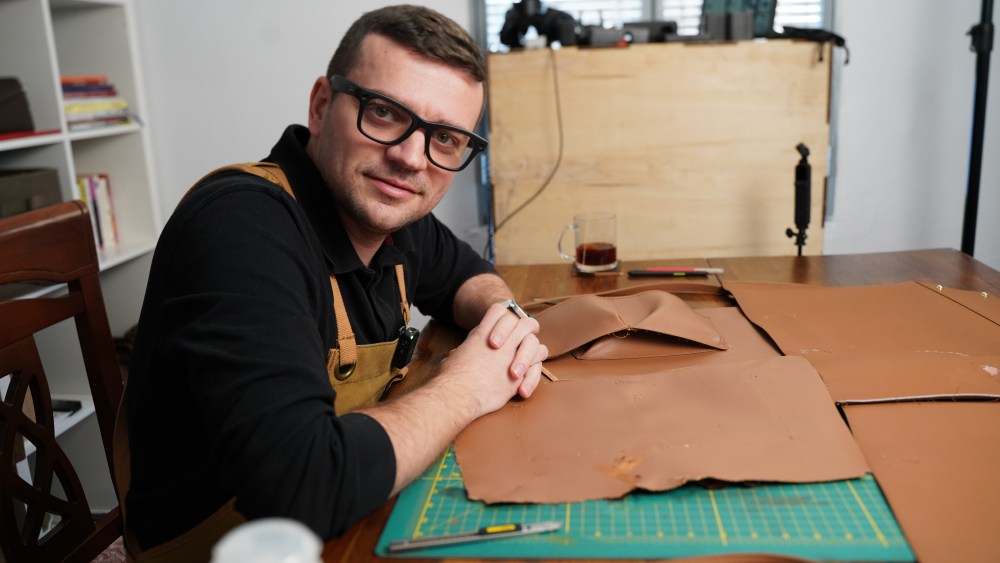wwd's tweet card. TikTok leather expert Tanner Leatherstein joins Stow London to elevate craftsmanship and design as the brand’s new Director of Craftsmanship.