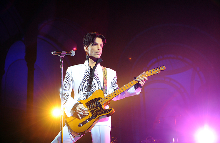 SeattleMedium's tweet card. Experience the brilliance of Prince in stunning IMAX as 'Sign O' The Times' is re-released. Relive the iconic concert film on August 28 at AMC theaters.