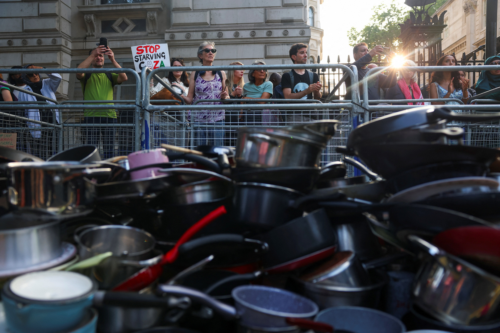 meadowasylum's tweet card. Protesters banged pots and pans on Downing Street in London to denounce Gaza’s urgent hunger crisis.