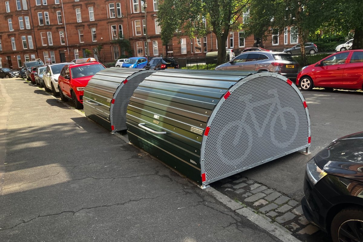 AngusCMillar's tweet card. Glasgow is set to expand its on-street cycle storage scheme with new spaces.