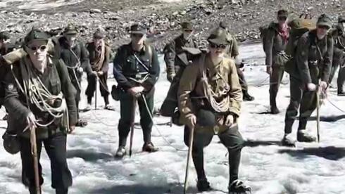 kpeterlBW's tweet card. Some 25 men wearing full Wehrmacht uniforms and Nazi insignia march through the Swiss Alps in alleged historical reenactment, sparking public outrage