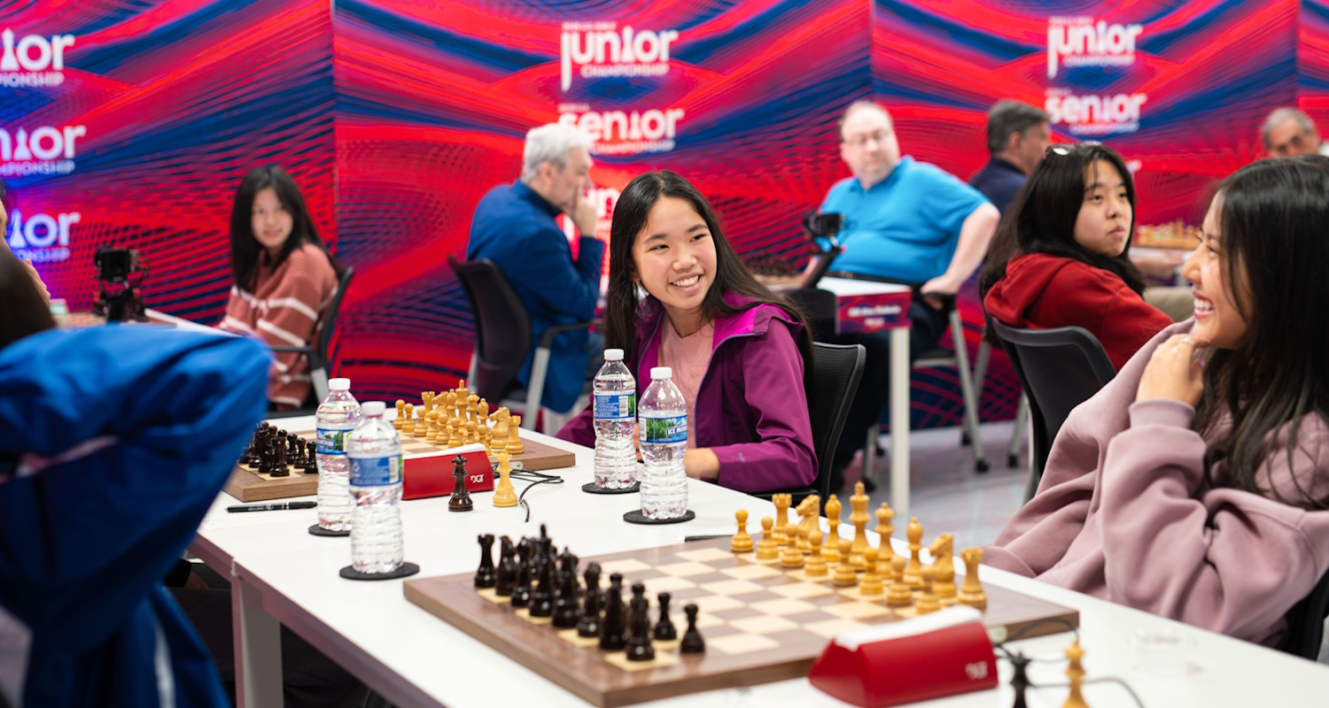 USChess's tweet card. As the U.S. Junior, Girls’ Junior, and Senior Championships approach the halfway point, the players continued to demonstrate keen fighting chess, battling for the coveted spot of tournament leader...